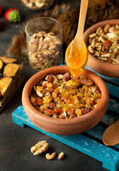 Hot sweets with nuts and honey bee in the pottery jar