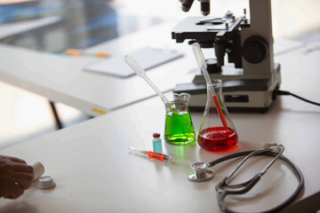 The doctor is testing a sample of biological tubes contaminated by Corona-virus Covid 19 and searching for a vaccine or Syrup against the virus. In the laboratory and film samples of infected lung