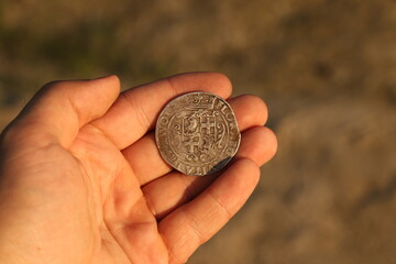 Silver medieval european coin in hand