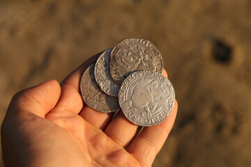 Silver medieval european coins in hand