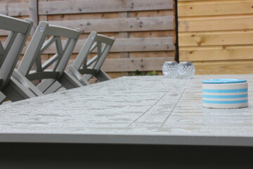 rained on garden table, leaving little bundles of water spread all over