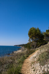 Fototapeta na wymiar Old dangerous path with view of the adriatic sea