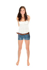 Full length portrait of a cheerful young woman wearing short blue jeans and a summer top, isolated on white studio background