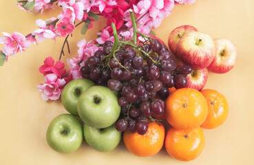 Grapes,Oranges and Apples put on background