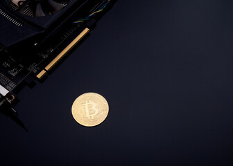bitcoin and video card on black background 
