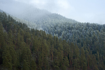 Winter mountain landscape. Small town between mountains. A cloud hangs over the city