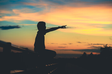 young beautiful woman looks hopeful at her hands at sunset.concept success in hand