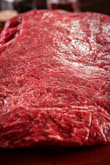 Marble denver beef on a wood resined cutting board - Closeup.