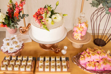 Wedding Setup. Cake table with sweet, decoration and flowers 