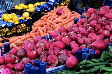 Fresh Organic Turnip and Carrot At A Street Market In Istanbul, Turkey, selective focus. Red radishes as background on the marketplace counter or fruit bazaar. Copy space for your text.