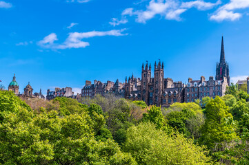 Fototapeta na wymiar A view from Princes Street Gardens towards the buildings on the Royal Mile in Edinburgh, Scotland on a summers day