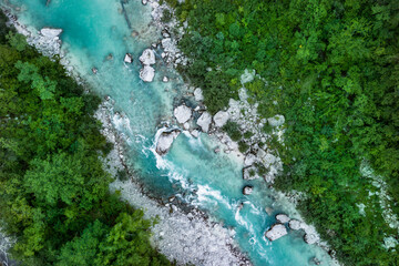 Aerial shot of blue Soča river with crystal clear water in the Soča valley (Slovenia)