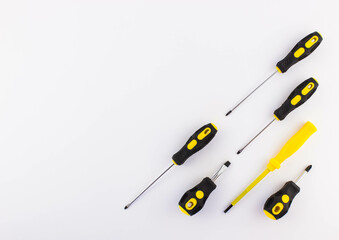 top view of set of yellow and black srewdrivers on white background. Repairing tools. Concept of work. Free copy space