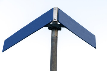 Traffic sign of two roads pointing in several directions, isolated against the background. a blue sign. 