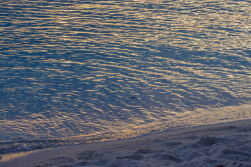 Small waves and tide washing up on the Dry Tortugas beach in the Gulf of Mexico at sunset