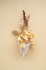 Menstrual cup with dried flowers. Abstract woman's health concept. Top view.