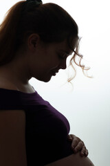 beautiful happy pregnant woman profile with hands on belly, future mother care and petting on a white isolated background, future life concept