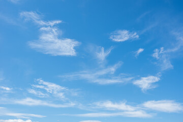 Naklejka na ściany i meble Little beautiful cirrus clouds in the blue sky. Perfect background of blue sky and white clouds for your photos, design layout.
