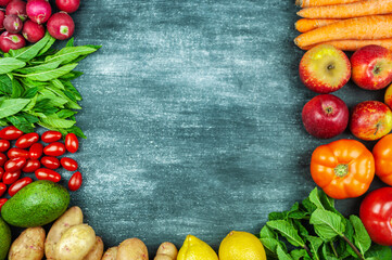 Flat lay of multi-colored raw vegetables on a black background, food frame. Local products for healthy cooking. Organic fruits and vegetables for vegetation. Top view. Copy space.