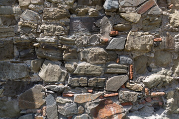 Wall texture from old raw bricks and stone. Old walls destroyed by time. Tbilisi, Georgia.