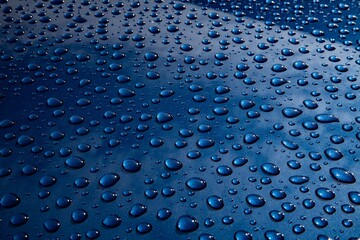Water drops on metal on car paint. Hydrophobic effect on metal surface