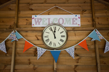 Buntin and welcome sign with a clock 
