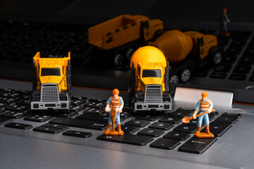 Heavy-duty vehicles model show on the black background.  and model of humans construction for...