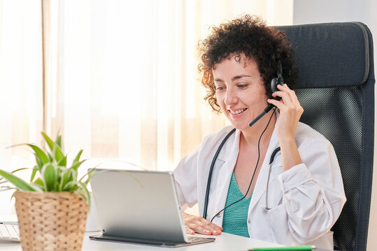 Female insurance doctor attends to patients via video call with a headset