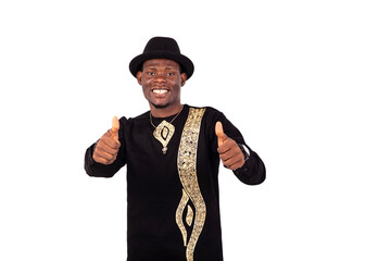 young happy man showing his thumbs up smiling.