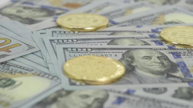 Dollars and bitcoins, Many Dollars and Bitcoins spinning on turntable, timelipse