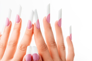 Well-groomed female hands with elegant french manicure on a white background. Long nails. Beauty salon. Photo for the catalog. High quality photo