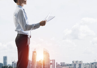 Concept of business success and control with confident boss against cityscape background