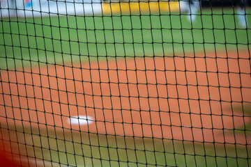 Baseball field with focus on protective net around the infield