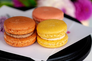 Three macarons. Tasty cakes of different color.  Concept very tasty dessert. Multicolored Macaroons. close-up