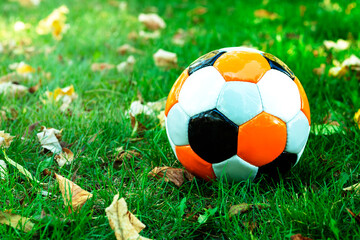 Classical soccerball on a green grass. Old soccer (football) ball on green field. Concept of playing soccer, match