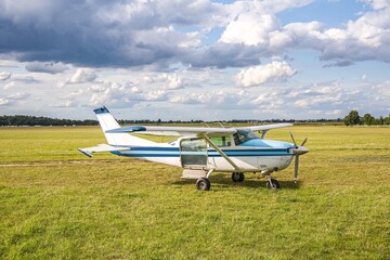 Fototapeta na wymiar white light aircraft for low altitude travel , Modern light aircraft, on a green field