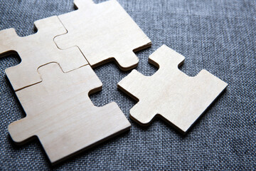 Three puzzle pieces in a row on a textile background