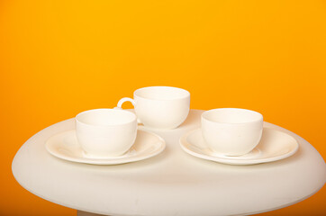 cup on a yellow background. Ceramic mug with saucer for tea or coffee
Place for text
White cup of coffee on a light wooden background. Vintage tones.