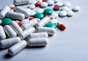 multicolored medical pills are scattered on the table