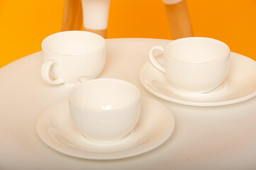 cup on a yellow background. Ceramic mug with saucer for tea or coffee
Place for text
White cup of coffee on a light wooden background. Vintage tones.