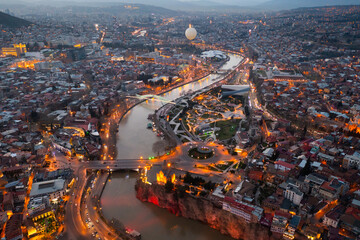 View from copter of illuminated center of Tbilisi city in the evening, Georgia