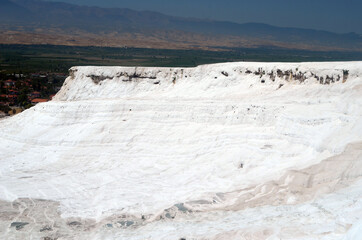 Natural travertine pools and terraces in Pamukkale. Cotton castle in southwestern Turkey. Pamukkale travertine and ancient city of Hierapolis.
