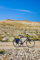Fototapeta premium a lonely bicycle in front of a barren landscape in croatia on island pag.