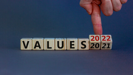 2022 values new year symbol. Businessman turns wooden cubes and changes words 'values 2021' to 'values 2022'. Beautiful grey background, copy space. Business, 2022 values new year concept.