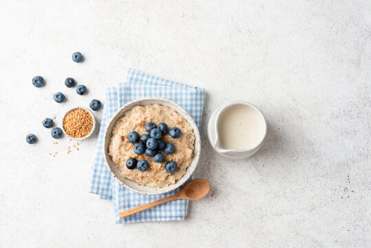 Oatmeal porridge with flax seeds and blueberries. Healthy vegan breakfast porridge