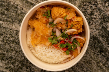 Delicious fried chicken with white rice or stream rice in the bucket. it's Crispy on the outside and soft on the inside. Fried Chicken crunchy on the outside and soft on the inside.