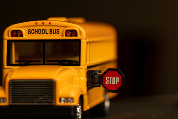 School bus model with stop sign. Do not pass the school bus. The stop signal arm. The school bus display a stop signal.
