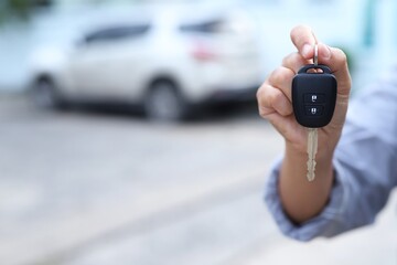 Woman showing keys to his new car