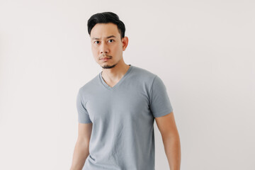 Normal portrait of an Asian man in a blue t-shirt isolated on white background.