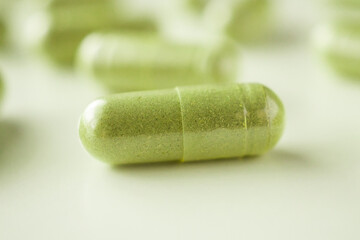 Herbal medicine capsules on white background